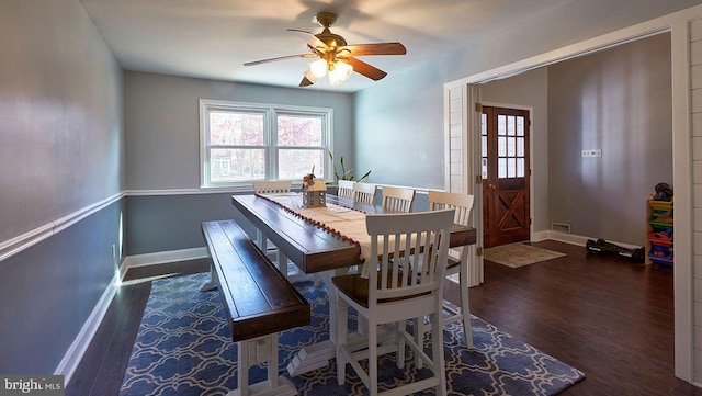 dining space with ceiling fan and dark hardwood / wood-style flooring