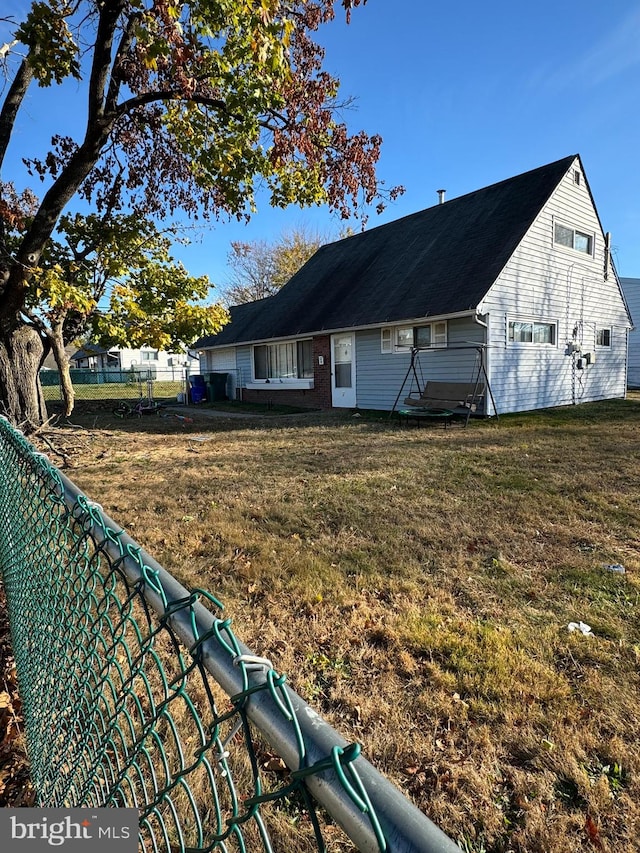 back of property with a lawn