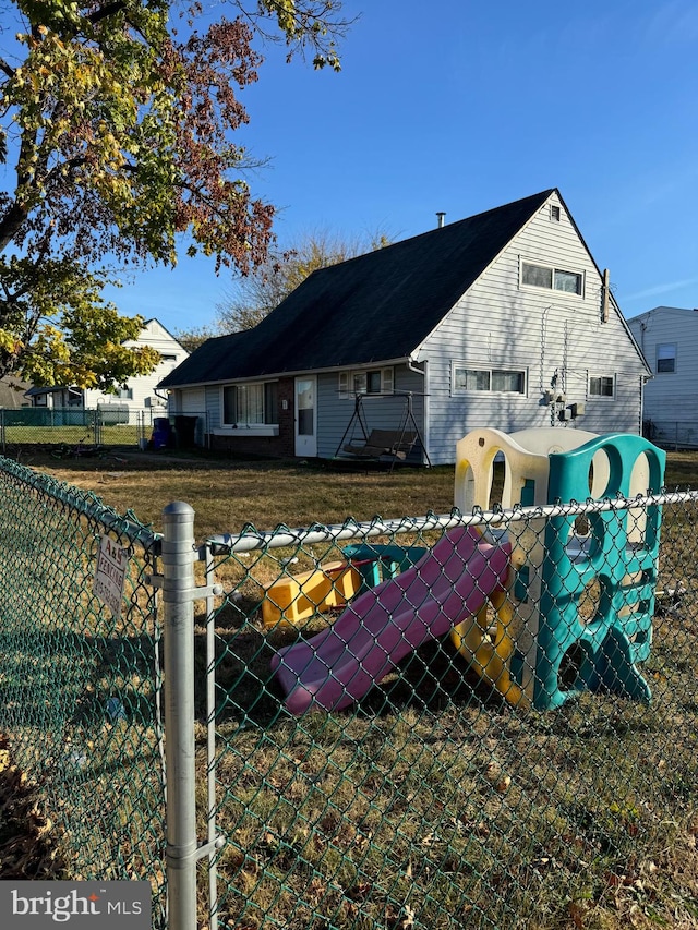 back of property featuring a yard