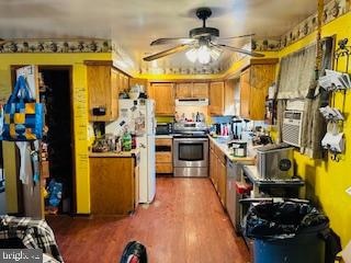 kitchen with ceiling fan, stainless steel range, wood-type flooring, and white refrigerator