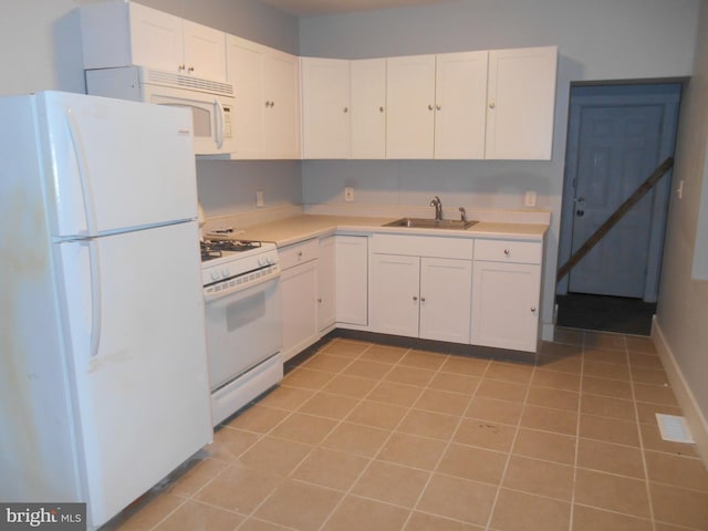 kitchen featuring white cabinets, white appliances, light tile patterned flooring, and sink