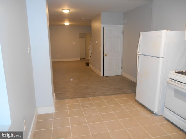 kitchen featuring light hardwood / wood-style floors and white appliances