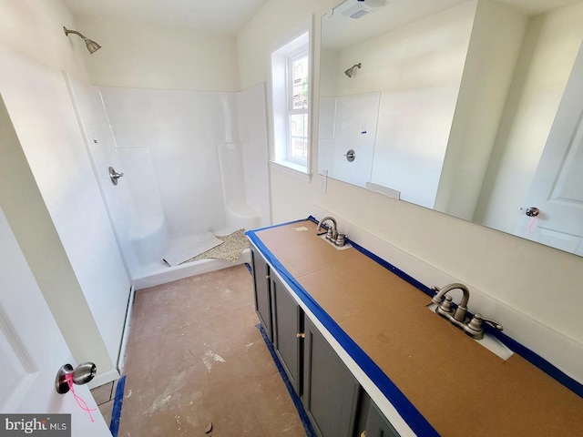 bathroom featuring vanity, concrete floors, and walk in shower