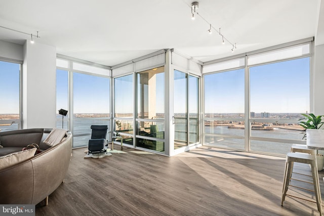 sunroom / solarium with a water view