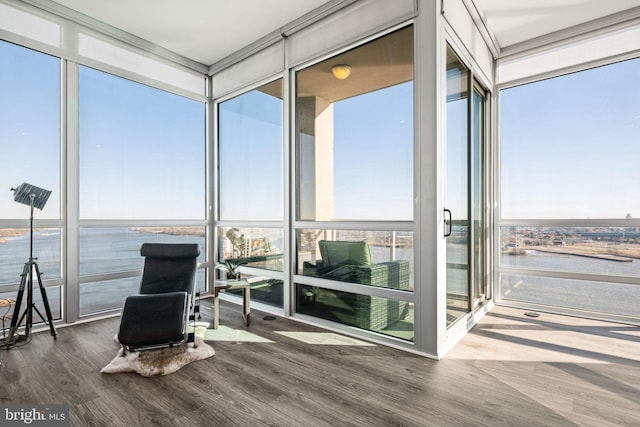 sunroom / solarium featuring a water view