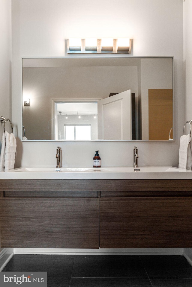 bathroom with tile patterned flooring and vanity