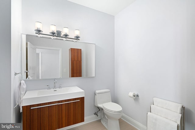 bathroom featuring radiator heating unit, vanity, and toilet