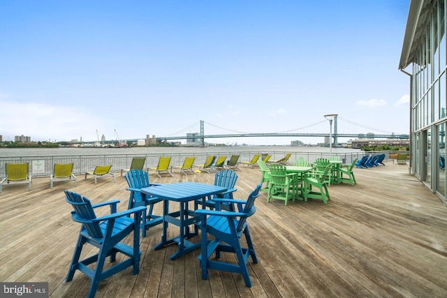 wooden terrace featuring a water view