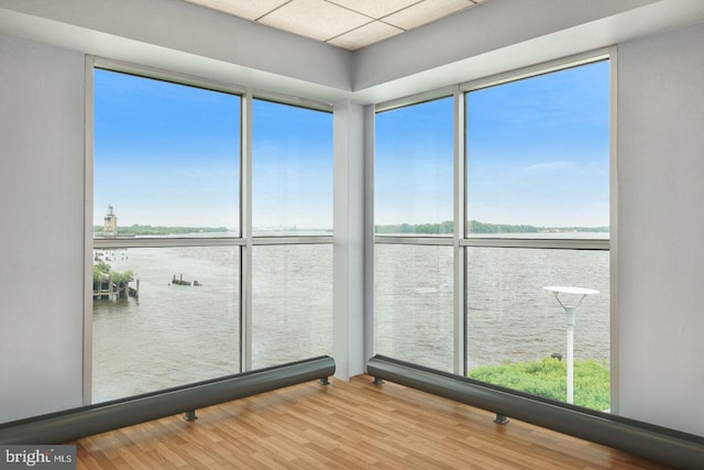 unfurnished sunroom featuring a water view