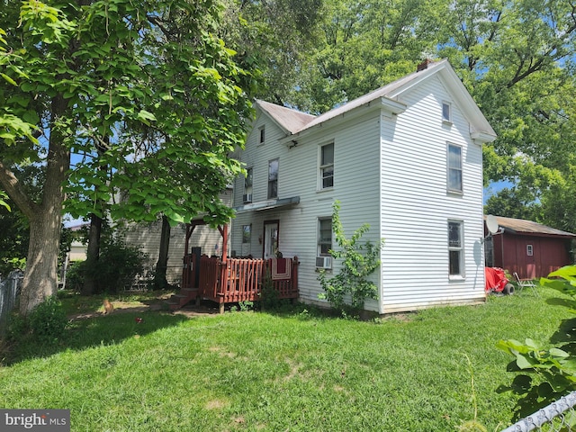 rear view of property with a yard