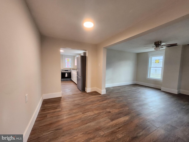 spare room with ceiling fan and dark hardwood / wood-style flooring