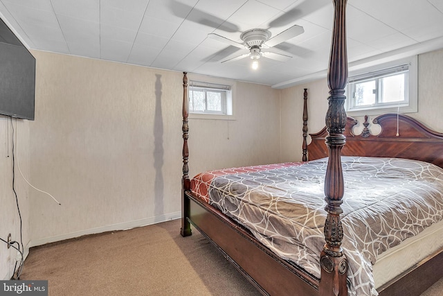 bedroom with multiple windows, ceiling fan, and carpet