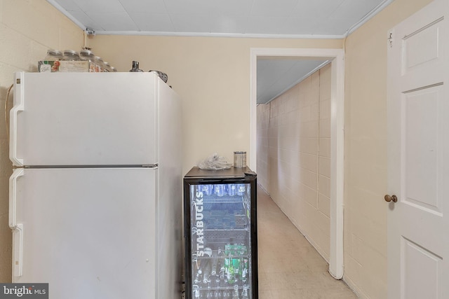 kitchen featuring white refrigerator and beverage cooler