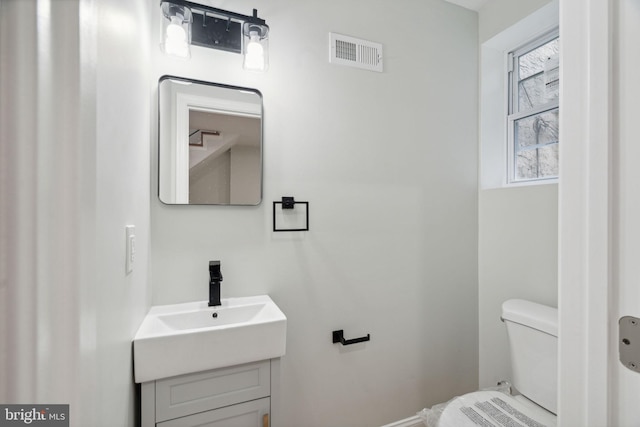 bathroom featuring vanity and toilet