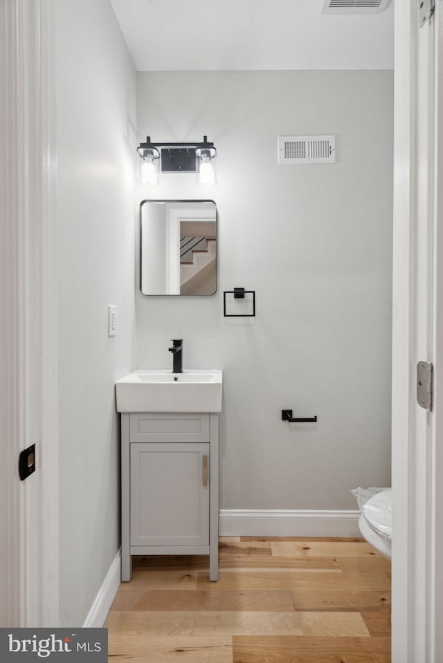 3013 Wharton St, Philadelphia, PA 19146 - bathroom featuring baseboards, wood finished floors, vanity, and toilet