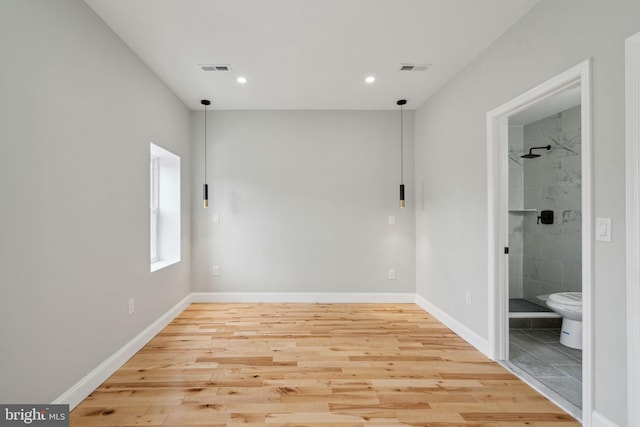 spare room with wood-type flooring