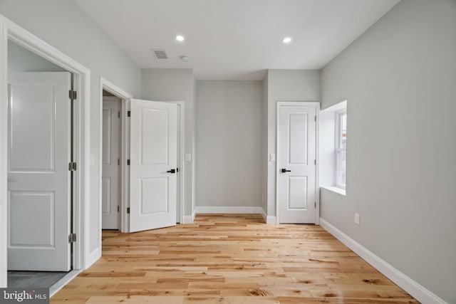 unfurnished bedroom with light wood-type flooring