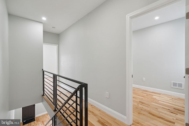 stairway with hardwood / wood-style flooring