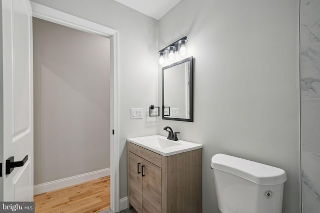 bathroom featuring vanity, toilet, and wood-type flooring