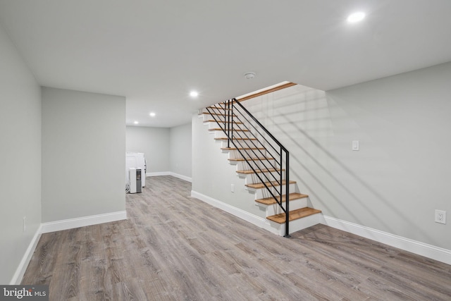 basement with light hardwood / wood-style flooring