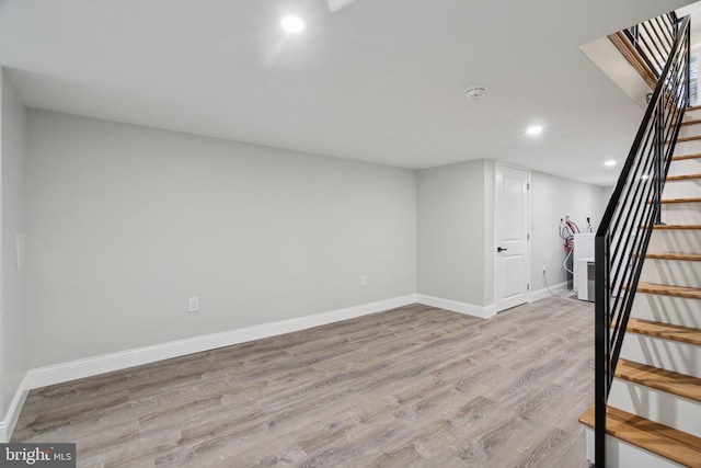 basement with light hardwood / wood-style flooring