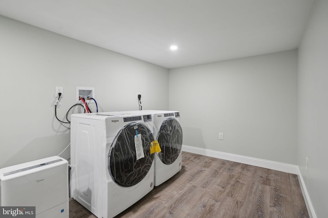 laundry area with hardwood / wood-style floors and independent washer and dryer