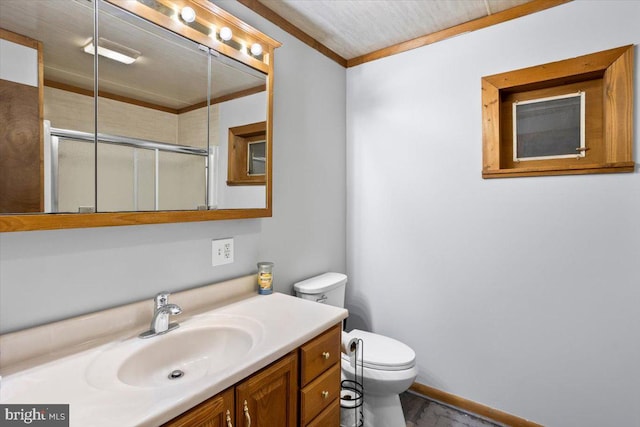 bathroom with vanity, toilet, an enclosed shower, and ornamental molding