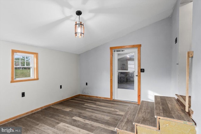 spare room featuring dark hardwood / wood-style floors and vaulted ceiling