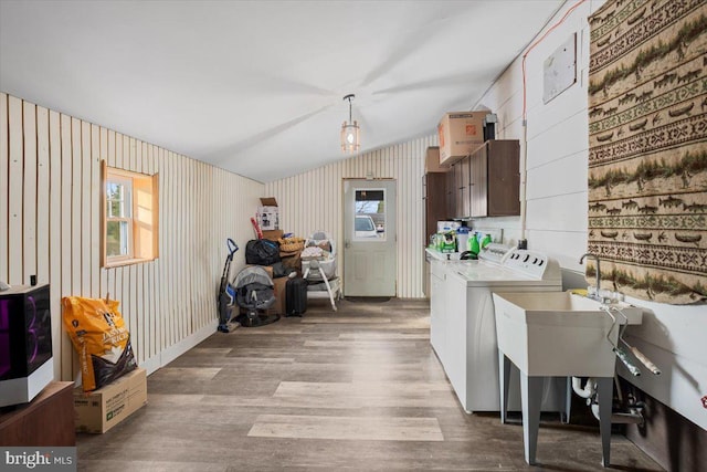 kitchen with washer and clothes dryer, lofted ceiling, a healthy amount of sunlight, and light wood-type flooring