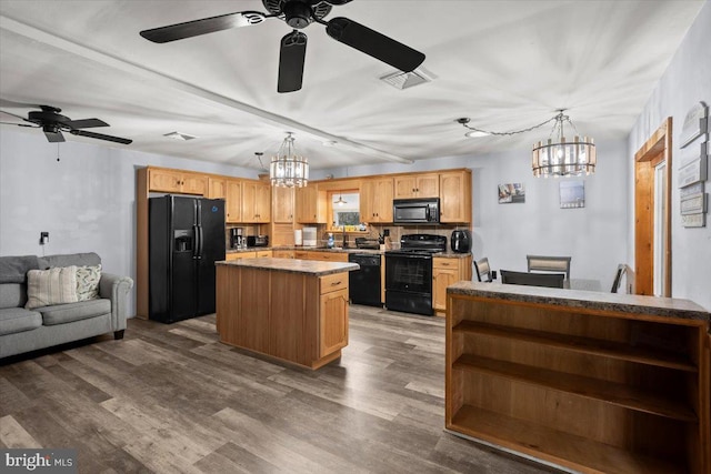 kitchen featuring black appliances, a kitchen island, dark hardwood / wood-style flooring, and light brown cabinetry