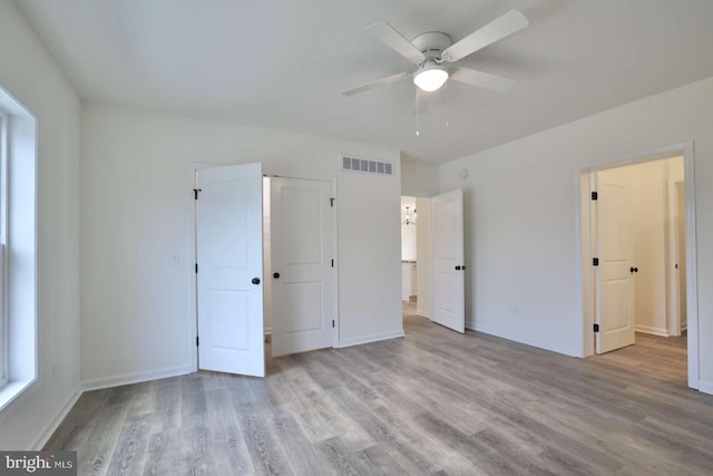 unfurnished bedroom with ceiling fan and light hardwood / wood-style flooring