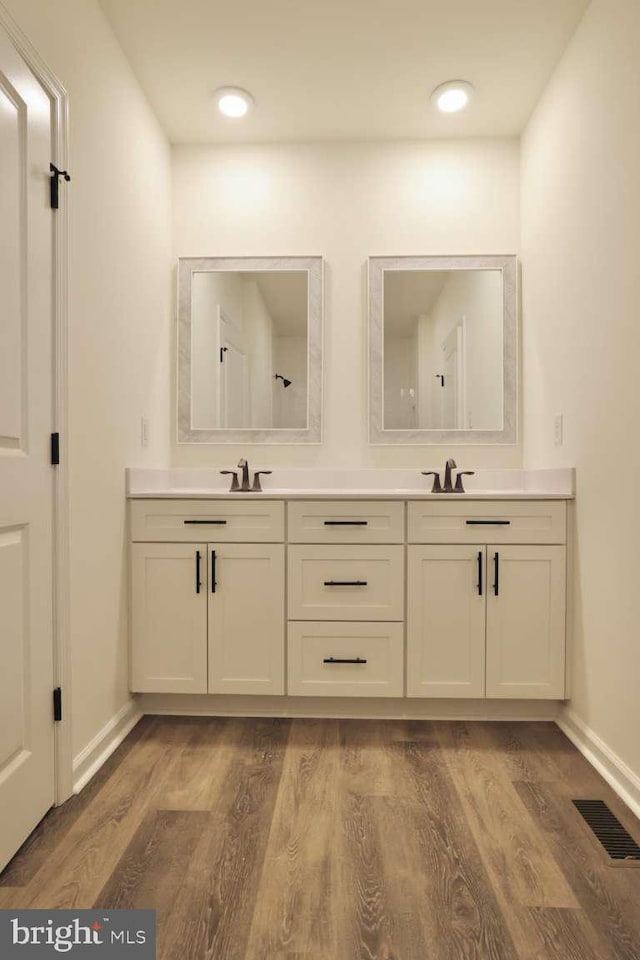 bathroom with vanity and hardwood / wood-style flooring