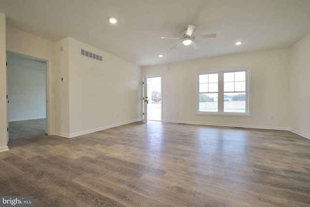 empty room with dark hardwood / wood-style floors and ceiling fan