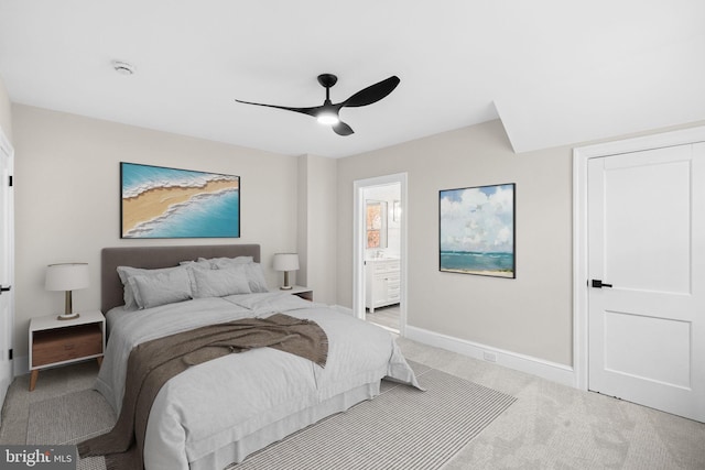 bedroom with connected bathroom, ceiling fan, and light colored carpet