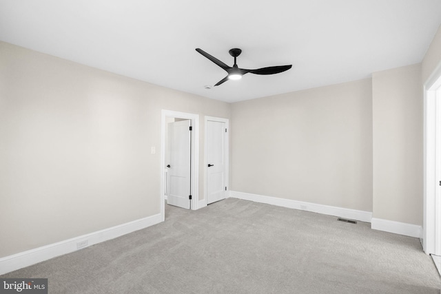 unfurnished bedroom with ceiling fan and light carpet