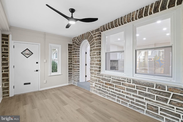 foyer entrance featuring light hardwood / wood-style flooring, ceiling fan, and ornamental molding