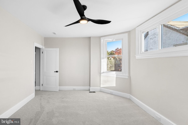 unfurnished room with light carpet and ceiling fan