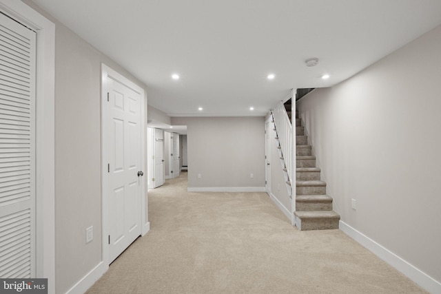 basement featuring light colored carpet