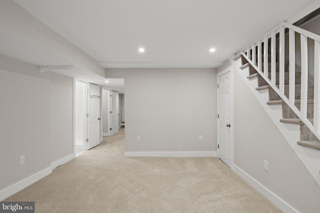 basement featuring light colored carpet