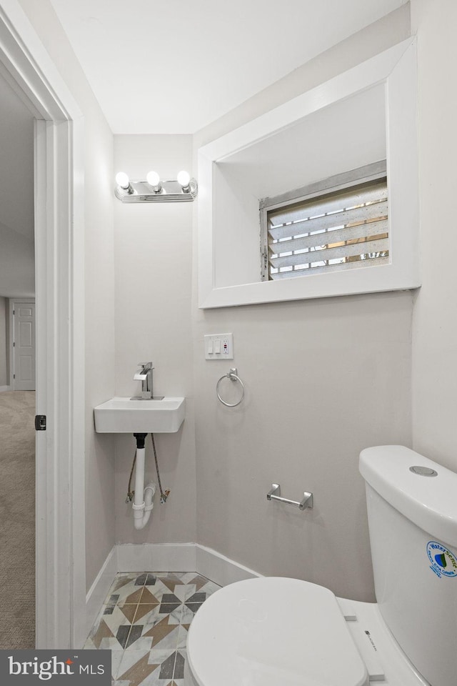 bathroom featuring tile patterned flooring and toilet