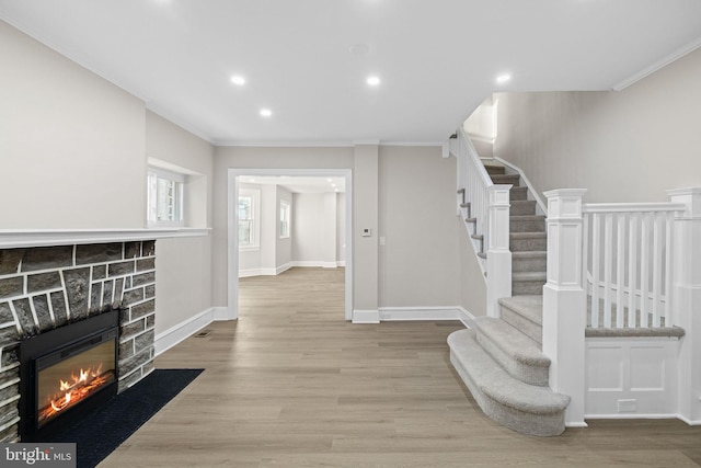 stairs featuring wood-type flooring and ornamental molding