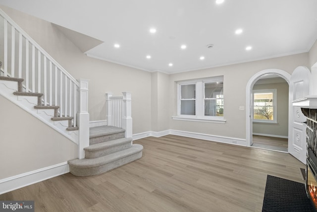 interior space featuring crown molding and light wood-type flooring