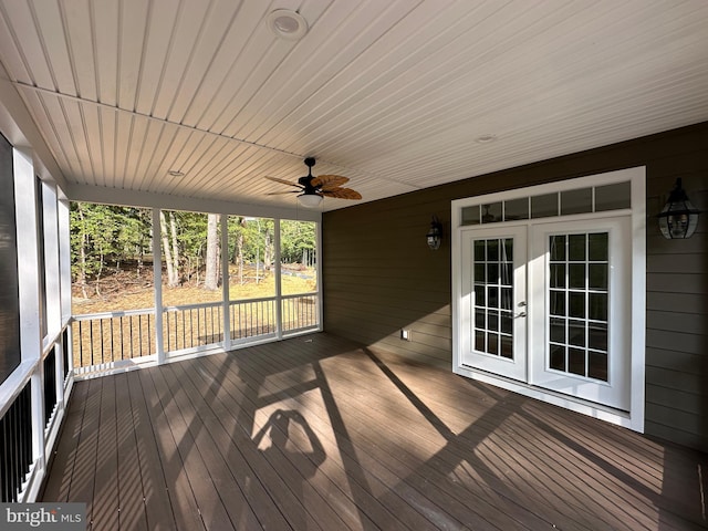 wooden deck with ceiling fan and french doors