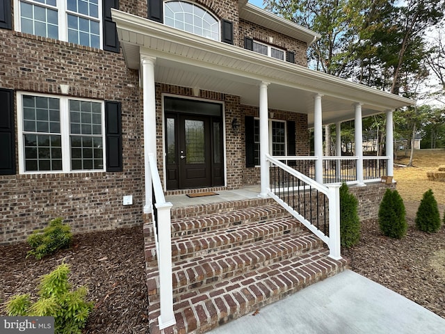 view of exterior entry featuring a porch