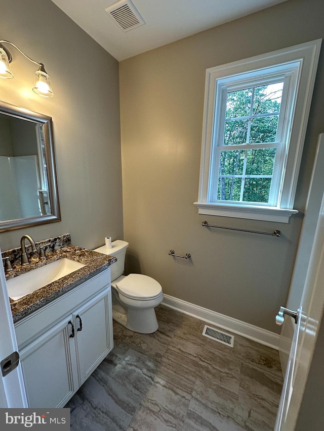 bathroom featuring vanity and toilet