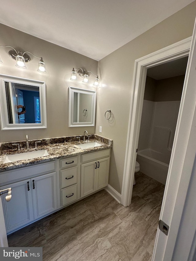 full bathroom with vanity, shower / bath combination, and toilet