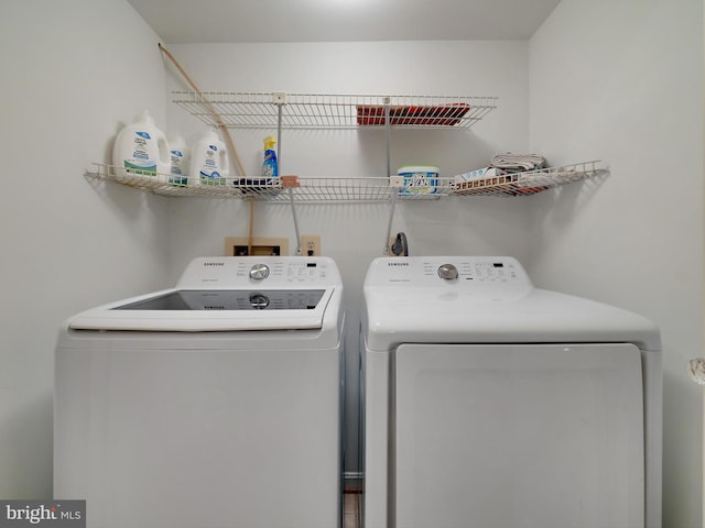 clothes washing area with washing machine and clothes dryer