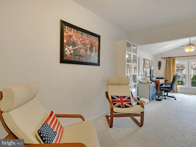 living area featuring light carpet, vaulted ceiling, and ceiling fan