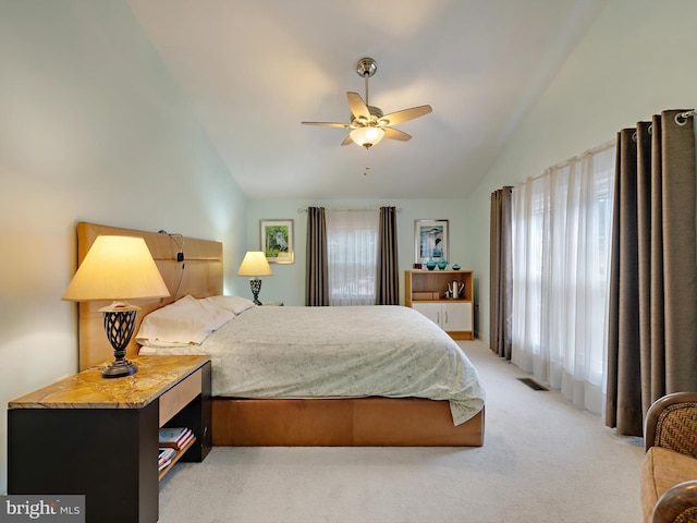 carpeted bedroom with ceiling fan and lofted ceiling