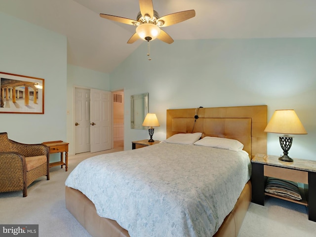 carpeted bedroom with ceiling fan and vaulted ceiling